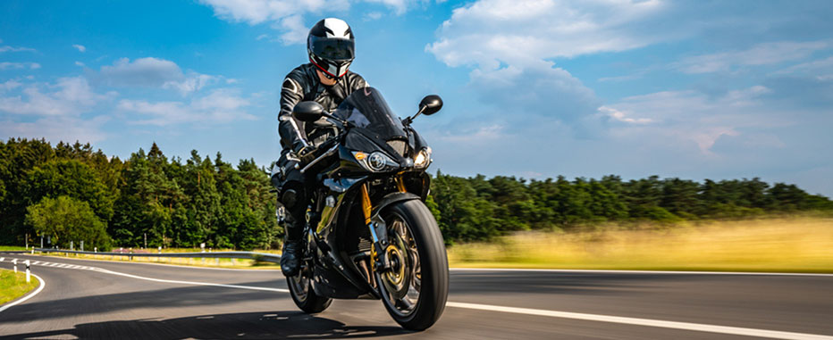 Motorcyclist wearing black gear and helmet - www.jjinsure.com/